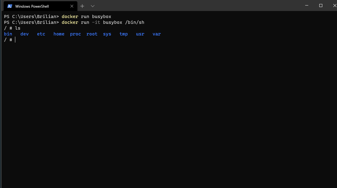 An interactive BusyBox shell listing the directories inside the container.